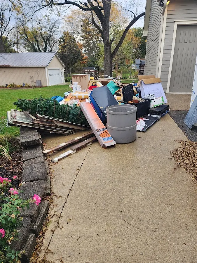Dumpster being loaded with debris for Estate Cleanout Dumpster Rental in Buckhannon